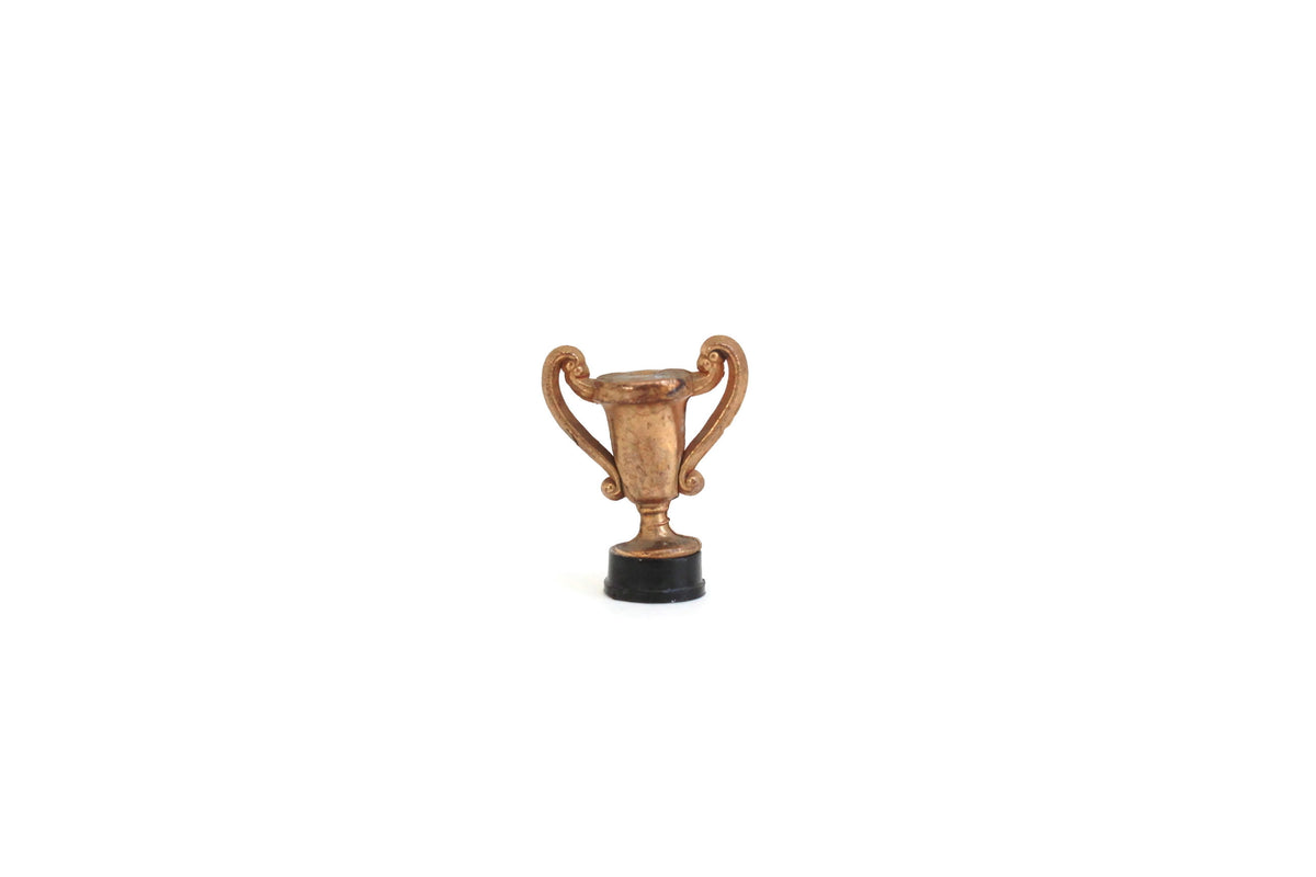 http://themustarddandelion.com/cdn/shop/products/GoldDollhouseTrophyFigurine_1_1200x1200.jpg?v=1625703295